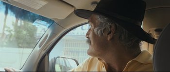 Movie still from “Cartel Land” (2015), directed by Matthew Heineman – An older man wearing a hat looking out of a car window; Close Up shot, Low angle