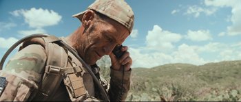 Movie still from “Cartel Land” (2015), directed by Matthew Heineman – A man in camouflage talking on a walkie talkie; Close Up shot, Over the shoulder angle