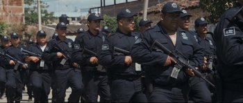 Movie still from “Cartel Land” (2015), directed by Matthew Heineman – A group of men in uniform marching down a street; Wide shot, Low angle