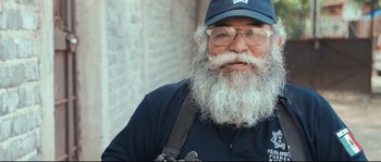 Movie still from “Cartel Land” (2015), directed by Matthew Heineman – An old man with a beard and glasses wearing a hat; Close Up shot, Low angle