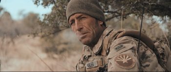 Movie still from “Cartel Land” (2015), directed by Matthew Heineman – A man in a military uniform wearing a hat; Close Up shot, Over the shoulder angle