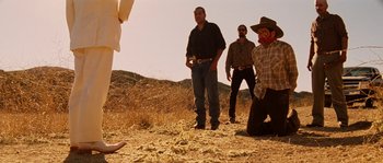 Movie still from “Casa de mi Padre” (2012), directed by Matt Piedmont – A group of men standing on top of a dry grass field; Wide shot, Low angle