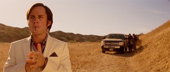 Movie still from “Casa de mi Padre” (2012), directed by Matt Piedmont – A man standing in front of a pick up truck in a field; Medium shot, Over the shoulder angle