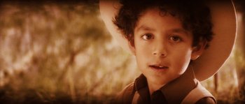 Movie still from “Casa de mi Padre” (2012), directed by Matt Piedmont – A young boy wearing a cowboy hat; Close Up shot, High angle