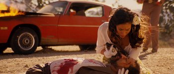 Movie still from “Casa de mi Padre” (2012), directed by Matt Piedmont – A woman in a white shirt is holding a cat; Close Up shot, Over the shoulder angle