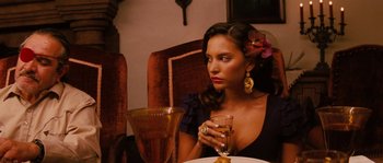 Movie still from “Casa de mi Padre” (2012), directed by Matt Piedmont – A woman sitting at a table with a glass of wine; Close Up shot, Over the shoulder angle