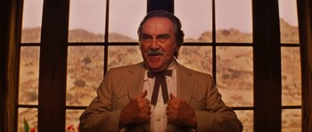 Movie still from “Casa de mi Padre” (2012), directed by Matt Piedmont – An older man in a suit and a bow tie; Close Up shot, Low angle