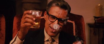 Movie still from “Casa de mi Padre” (2012), directed by Matt Piedmont – A man smoking a cigarette while holding a glass of alcohol; Close Up shot, Low angle