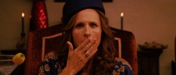 Movie still from “Casa de mi Padre” (2012), directed by Matt Piedmont – A person covering her mouth with her hands; Close Up shot, Over the shoulder angle