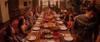 Movie still from “Casa de mi Padre” (2012), directed by Matt Piedmont – A group of people sitting around a long dinner table; Wide shot, High angle
