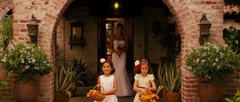 Movie still from “Casa de mi Padre” (2012), directed by Matt Piedmont – Two little girls in white dresses holding yellow baskets; Wide shot, Low angle