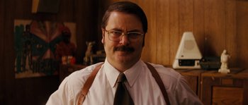 Movie still from “Casa de mi Padre” (2012), directed by Matt Piedmont – A person wearing glasses and a tie; Close Up shot, Low angle