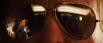 Movie still from “Casa de mi Padre” (2012), directed by Matt Piedmont – A person's face wearing a pair of sunglasses; Extreme Close Up shot, Low angle