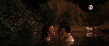 Movie still from “Casa de mi Padre” (2012), directed by Matt Piedmont – A man and a woman in the water at the edge of a cliff; Medium shot, High angle