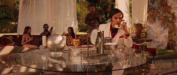 Movie still from “Casa de mi Padre” (2012), directed by Matt Piedmont – A man sitting at a table talking on the phone; Medium shot, Low angle