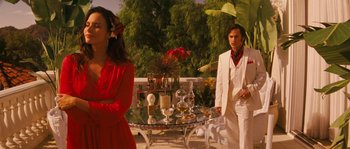 Movie still from “Casa de mi Padre” (2012), directed by Matt Piedmont – A man and a woman standing next to a glass table; Medium shot, Over the shoulder angle