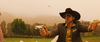 Movie still from “Casa de mi Padre” (2012), directed by Matt Piedmont – A man in a cowboy hat holding a gun in his hand; Medium shot, Low angle