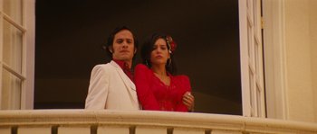 Movie still from “Casa de mi Padre” (2012), directed by Matt Piedmont – A man and a woman standing next to a railing; Medium shot, Low angle