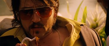 Movie still from “Casa de mi Padre” (2012), directed by Matt Piedmont – A person wearing sunglasses smoking a cigarette; Close Up shot, Low angle
