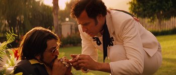 Movie still from “Casa de mi Padre” (2012), directed by Matt Piedmont – A man and a woman eating food in the grass; Close Up shot, Low angle