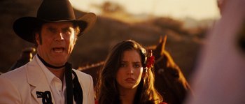 Movie still from “Casa de mi Padre” (2012), directed by Matt Piedmont – A woman in a cowboy hat standing next to a man in a cowboy outfit; Close Up shot, Low angle