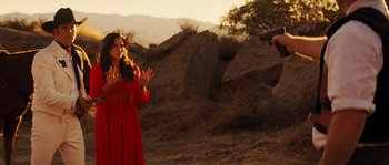 Movie still from “Casa de mi Padre” (2012), directed by Matt Piedmont – A woman in a red dress and a man in a red suit; Medium shot, Over the shoulder angle