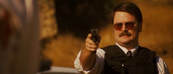Movie still from “Casa de mi Padre” (2012), directed by Matt Piedmont – A man with a mustache holding a gun in his hand; Close Up shot, Low angle