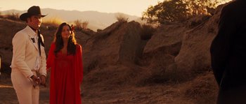 Movie still from “Casa de mi Padre” (2012), directed by Matt Piedmont – A woman in a red dress standing in a field; Wide shot, Over the shoulder angle