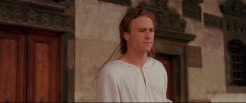 Movie still from “Casanova” (2005), directed by Lasse Hallström – A man with long brown hair wearing a white shirt; Close Up shot, High angle