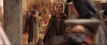 Movie still from “Casanova” (2005), directed by Lasse Hallström – A young woman in a dress and a cape walking down a street; Medium shot, Over the shoulder angle