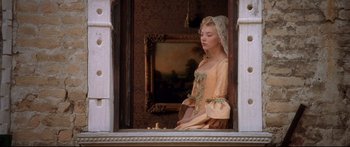 Movie still from “Casanova” (2005), directed by Lasse Hallström – A young woman in an old - fashioned dress looking out of a window; Medium shot, Low angle
