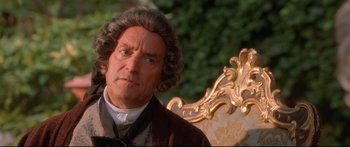 Movie still from “Casanova” (2005), directed by Lasse Hallström – A man in a brown jacket sitting on a chair; Close Up shot, High angle