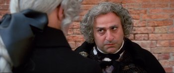 Movie still from “Casanova” (2005), directed by Lasse Hallström – A man in a black tuxedo looking at himself in the mirror; Close Up shot, Over the shoulder angle