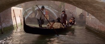 Movie still from “Casanova” (2005), directed by Lasse Hallström – A group of people riding on a boat on a body of water; Wide shot, High angle