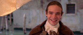 Movie still from “Casanova” (2005), directed by Lasse Hallström – A young man in a bow tie smiling for the camera; Close Up shot, High angle