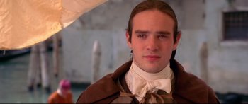 Movie still from “Casanova” (2005), directed by Lasse Hallström – A man in a brown jacket and a white bow tie; Close Up shot, Over the shoulder angle