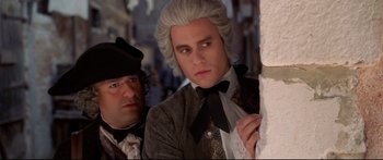 Movie still from “Casanova” (2005), directed by Lasse Hallström – A man in a suit standing next to another man in a suit; Close Up shot, Over the shoulder angle