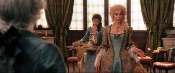 Movie still from “Casanova” (2005), directed by Lasse Hallström – Two women dressed in period costumes standing in front of a table; Medium shot, Over the shoulder angle