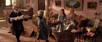 Movie still from “Casanova” (2005), directed by Lasse Hallström – A group of people sitting around a living room together; Wide shot, High angle