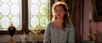 Movie still from “Casanova” (2005), directed by Lasse Hallström – A woman in a green dress standing in front of a window; Medium shot, Over the shoulder angle