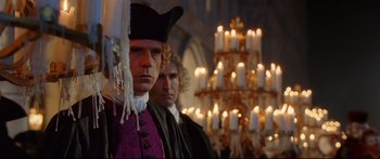 Movie still from “Casanova” (2005), directed by Lasse Hallström – Two men standing next to each other in front of a chandelier; Medium shot, Low angle