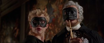 Movie still from “Casanova” (2005), directed by Lasse Hallström – A man and a woman wearing masks and holding a stick; Medium shot, Low angle