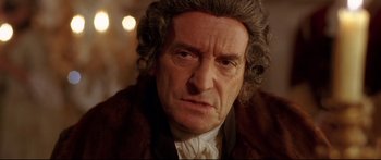 Movie still from “Casanova” (2005), directed by Lasse Hallström – An old man with a beard and curly grey hair; Close Up shot, Over the shoulder angle