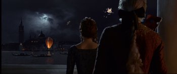 Movie still from “Casanova” (2005), directed by Lasse Hallström – A man and a woman looking out at fireworks; Wide shot, Low angle