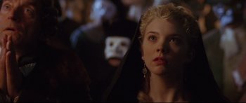 Movie still from “Casanova” (2005), directed by Lasse Hallström – A young woman in a black and white mask; Close Up shot, Over the shoulder angle