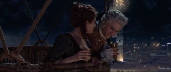 Movie still from “Casanova” (2005), directed by Lasse Hallström – A man and a woman sitting next to each other holding drinks; Medium shot, Low angle