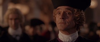 Movie still from “Casanova” (2005), directed by Lasse Hallström – A person wearing a hat and looking at the camera; Close Up shot, Over the shoulder angle