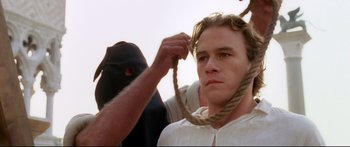 Movie still from “Casanova” (2005), directed by Lasse Hallström – A man holding a rope around a man's neck; Close Up shot, Over the shoulder angle
