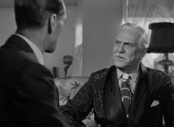 Movie still from “Casanova Brown” (1944), directed by Sam Wood – Two men in suits talking to each other in a living room; Close Up shot, Over the shoulder angle