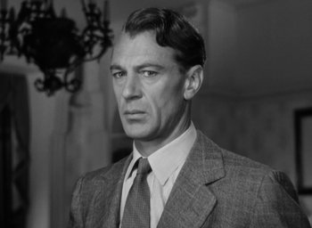 Movie still from “Casanova Brown” (1944), directed by Sam Wood – Black and white photograph of a man wearing a suit and tie; Close Up shot, Low angle